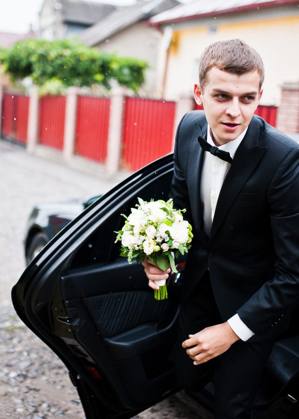 stylish-young-groom-out-of-the-wedding-car-in-rain-2021-09-02-12-44-44-utc (1)